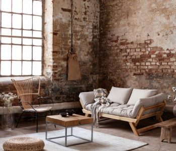 armchair-and-beige-sofa-in-industrial-living-room-interior-with.jpg
